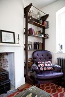 Wooden shelving and purple armchair
