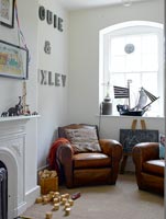 Childs room with leather armchairs