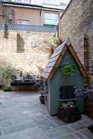 Walled garden with wooden wendy house