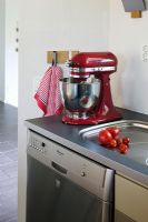 Red food mixer in kitchen corner