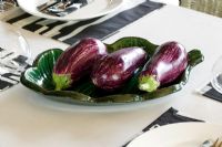 Aubergines on green plate