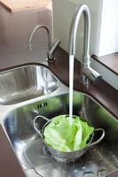 Rinsing lettuce in kitchen sink