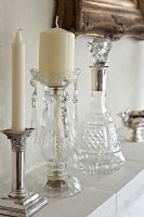 Glass and silverware on stone mantelpiece