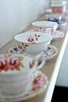 Collection of tea cups on shelf