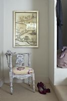 Ornate chair under decorative print