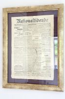 Vintage newspaper clipping in gold frame