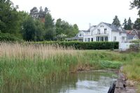 Classic country house exterior and pond 