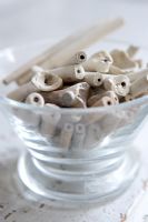 Collection of clay pipes in glass bowl, detail