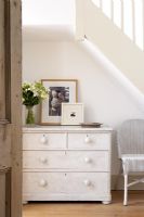 Distressed chest of drawers under staircase