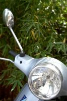 Silver scooter headlight, detail