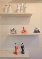Display of figurines on white shelves