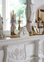 Classic clock and ornaments on mantelpiece 