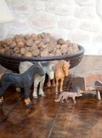 Wooden animal toys and bowl of nuts