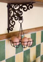 Eggs in wire work basket suspended from wooden shelf