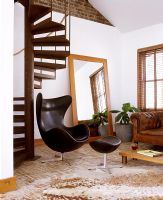 Leather chair next to spiral staircase