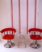 Red retro chairs and striped wallpaper