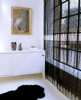 Black lace curtains and white sideboard
