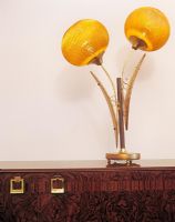 Lamp with glass shades on cabinet