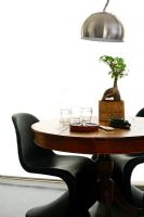 Round dining table and contemporary plastic chairs