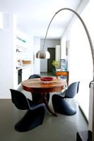 Round dining table and contemporary plastic chairs
 
