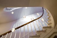 Classic staircase with modern pendant lights