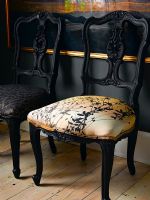 Ornate chairs upholstered with modern fabric