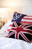 Cushions made from old flags on bed