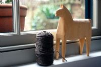 Twine and horse ornament on windowsill