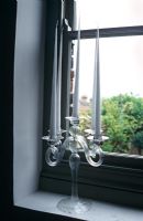 Vintage candlestick on windowsill