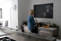 Woman using toaster in contemporary kitchen