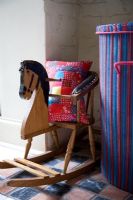 Colourful striped basket and rocking horse seat