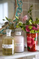 Flowers and toiletries on bathroom shelf