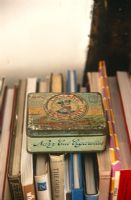 Vintage cigarette tin on bookshelf