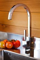 Kitchen tap and wooden panelling