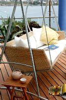 Contemporary swing seat on deck with sea view