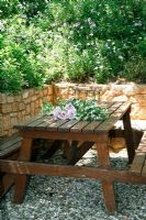 Wooden table on gravel patio