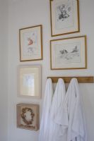Display of paintings over towel hooks 