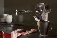 Kitchen utensils in metal jug