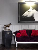 Horse artwork next to sofa
