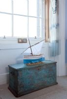 Distressed storage trunk in country bedroom 