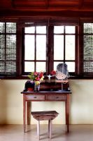 Wooden dressing table under window