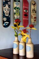 Tropical flowers in earthenware bottles
