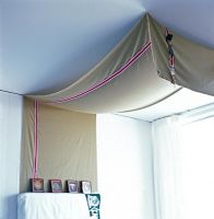 Grey canopy above bed