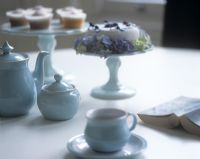 Tea set and cakes on dining table
