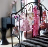 Bags and accessories on iron bedstead 