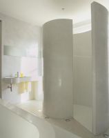 Modern bathroom with curved shower wall 