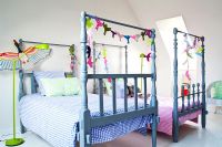 Two four poster beds in childrens room 