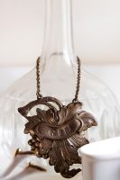 Brass chain around decanter detail 