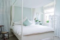 Modern bedroom with four poster bed 