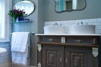 Twin sinks on ornate wooden cabinet